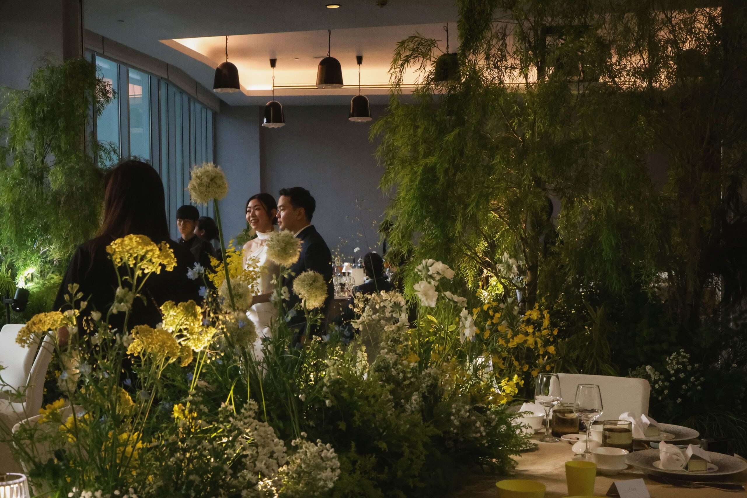 Overview of a unique intimate wedding featuring tree-inspired floral installations, cascading white flowers and immersive wedding styling at W Singapore.