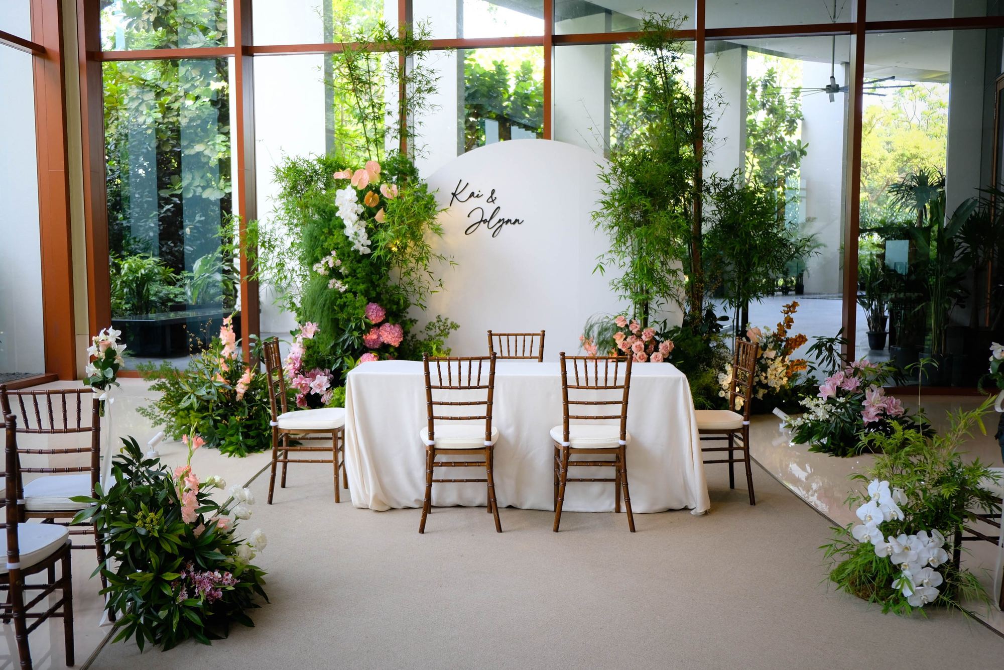 Clifford Pier oriental wedding with a white moon arch framed by bamboo and soft blooms, Singapore